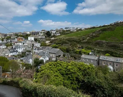 a city with houses on a hill and a town at April Cottage in Port Isaac