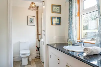 a bathroom with a sink and a toilet at Trevan House Lundy in Polzeath