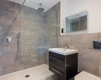 a bathroom with a shower and a sink and a toilet at Greenaway, 4 Rockhaven Gardens in Saint Minver