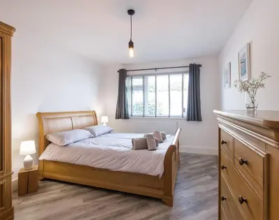 a bedroom with a bed and a window at Greenaway, 4 Rockhaven Gardens in Saint Minver