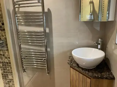 a bathroom with a white sink and a shower at Lavender Barn in Newquay