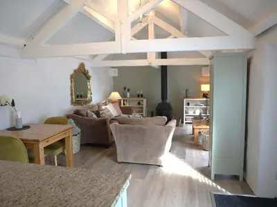 a living room with a couch and a table at Lavender Barn in Newquay