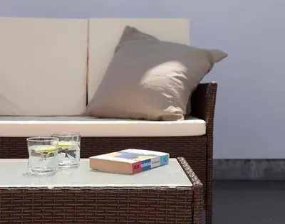 a table with a book and two glasses and a pillow at The Crows Nest in Port Isaac