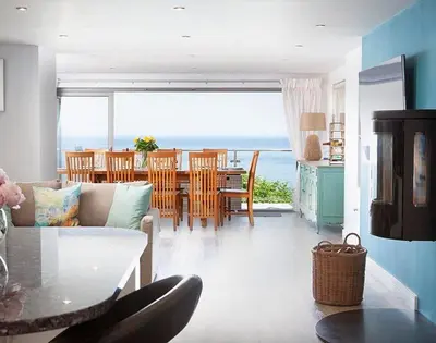 a living room with a view of the ocean at The Crows Nest in Port Isaac