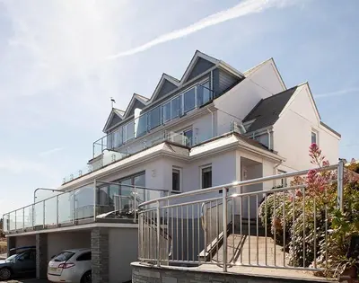 a large white house with a large balcony at The Crows Nest in Port Isaac