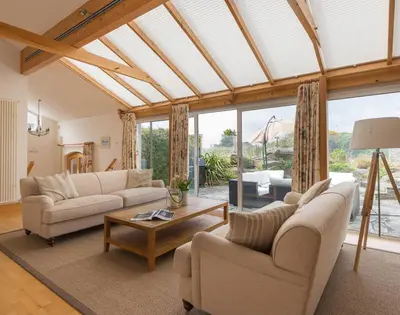 a living room with two couches and a table at Penny Liggan in Padstow
