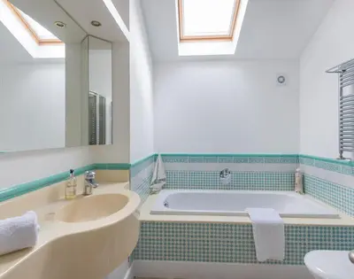 a bathroom with a tub and a sink and a mirror at Penny Liggan in Padstow