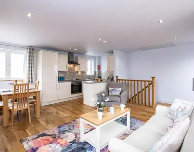a living room with a couch and a table at The Hideaway in Port Isaac