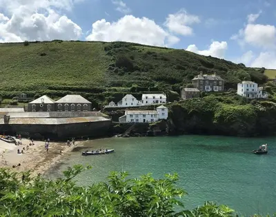 a group of people on a beach near a body of water at The Hideaway in Port Isaac