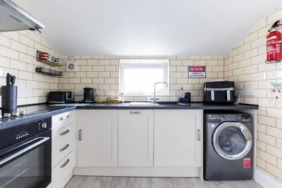 a kitchen with a washer and a washing machine at Number 28 in Port Isaac
