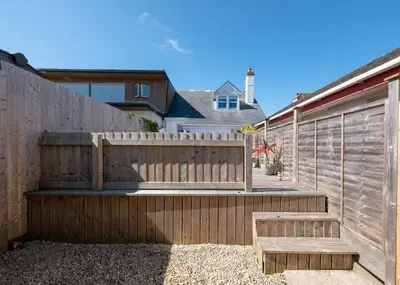 a wooden fence with a bench in front of it at Number 28 in Port Isaac