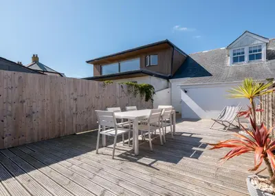 a patio with a table and chairs on a deck at Number 28 in Port Isaac