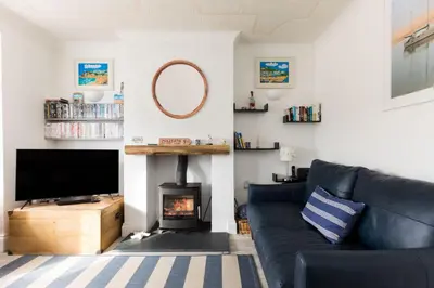 a living room with a couch and a fireplace at Number 28 in Port Isaac