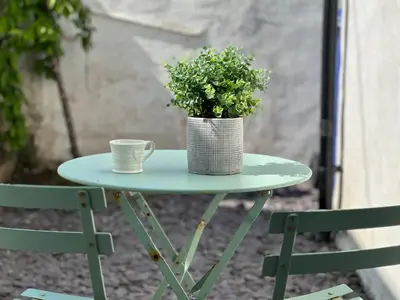 a table with a cup and a potted plant on it at 1 Tintagel in Port Isaac