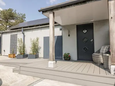 a house with a wooden porch with a black door at Westfields in Launceston
