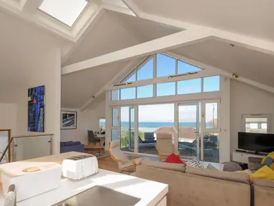 a living room with a view of the ocean at Drishti in Polzeath