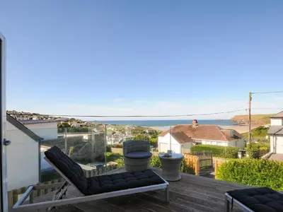 a view of the ocean from the balcony of a house at Drishti in Polzeath