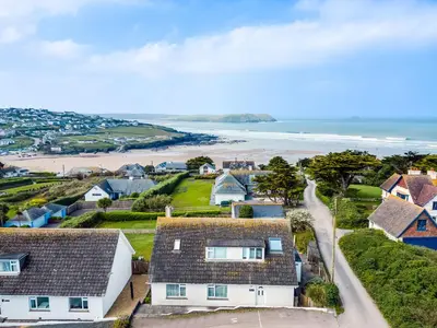 an aerial view of a coastal town with houses and the beach at Bella Vista in Polzeath