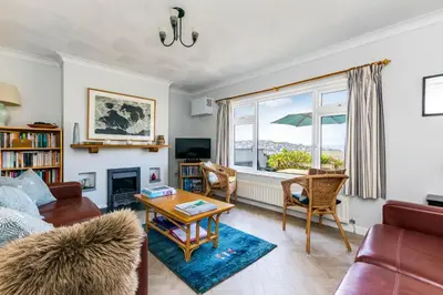 a living room with a couch and a table at Bella Vista in Polzeath