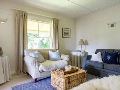 a living room with a couch and a chair at Sandy Lodge Rock in Padstow