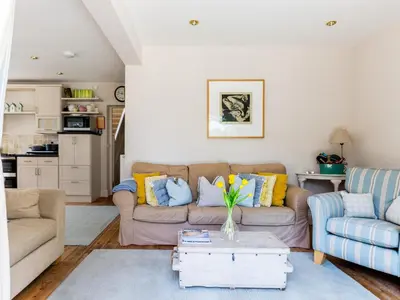 a living room with a couch and a table at Sandy Lodge Rock in Padstow