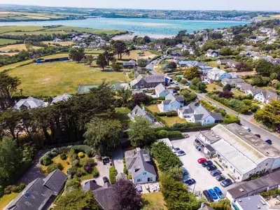 an aerial view of a residential neighborhood with houses and the water at Sandy Lodge Rock in Padstow