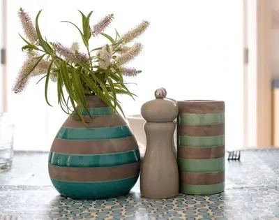 two vases sitting on a table with a plant at St Martins Apartment in Saint Minver