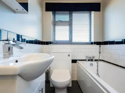 a bathroom with a sink and a toilet and a tub at Hillview in Wadebridge