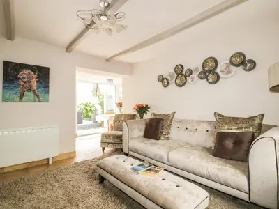 a living room with a couch and a table at Blue Crab Cottage in St Austell