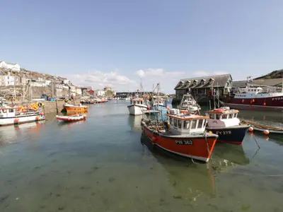 a group of boats are docked in a harbor at Blue Crab Cottage in St Austell