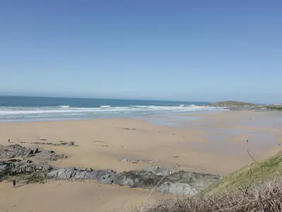 a sandy beach with the ocean in the background at Fistral Drift in Newquay