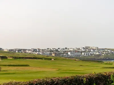 a golf green with a city in the background at Fistral Drift in Newquay