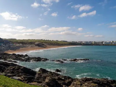 a view of a beach with rocks and the ocean at Fistral Drift in Newquay