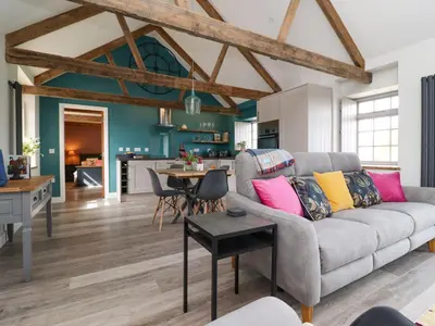 a living room with a couch and a table at The Roost in Helston