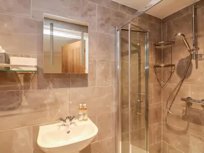 a bathroom with a sink and a shower at The Old Byre in Falmouth