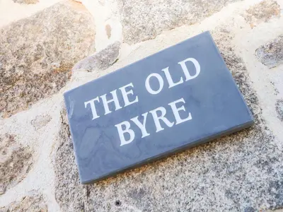 a sign that says the old syringe on a rock at The Old Byre in Falmouth