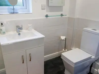 a bathroom with a white sink and a toilet at The Old Vicarage Retreat in Bodmin
