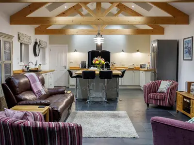 a kitchen with a couch and a table with chairs at The Old Vicarage Retreat in Bodmin