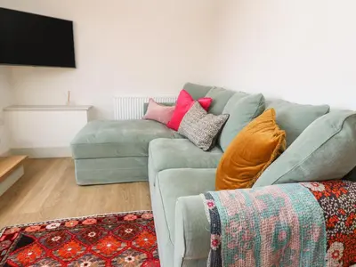 a living room with a couch and a tv at 16 Arwenack Street in Falmouth