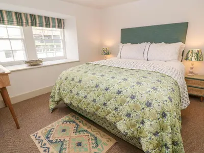a bedroom with a large bed and a window at 16 Arwenack Street in Falmouth
