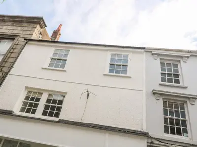 a white house with windows on the side of it at 16 Arwenack Street in Falmouth