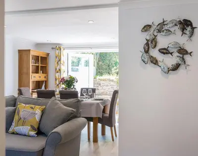 a living room with a couch and a table at Stop Tide in Port Isaac