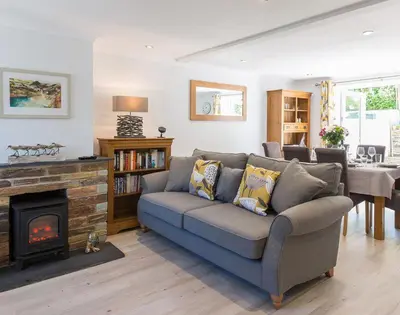 a living room with a couch and a fireplace at Stop Tide in Port Isaac