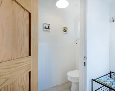 a bathroom with a white toilet and a white sink at Stop Tide in Port Isaac