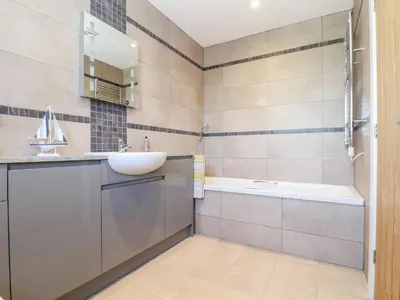a bathroom with a sink and a tub at Chy-Whel in St Austell