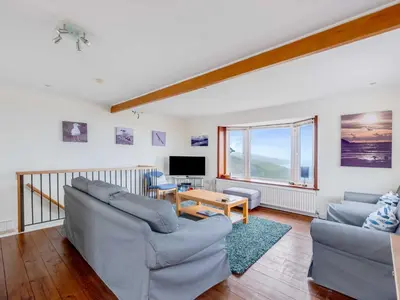 a living room with two couches and a tv at Shilling Stones in Port Isaac