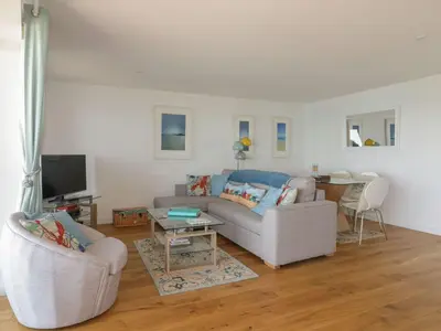 a living room with a couch and a table at Onshore in Newquay