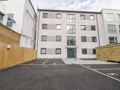 an empty parking lot in front of a building at Onshore in Newquay