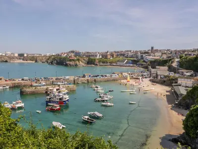 a group of boats in the water in a harbor at Onshore in Newquay
