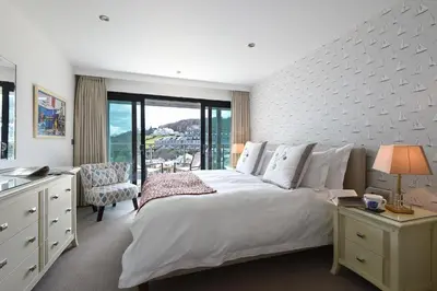 a bedroom with a large white bed and a window at The Boats in St Ives